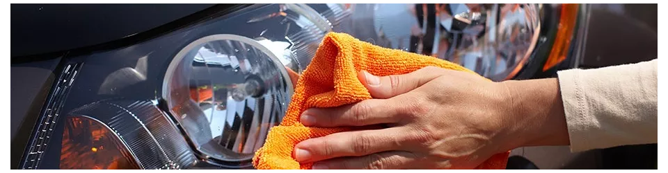 Le nettoyage de la voiture. La main avec chiffon microfibre